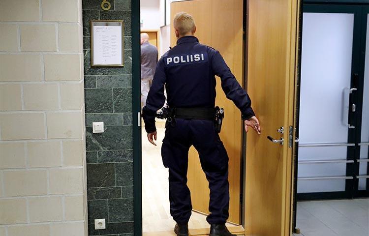 A police officer is seen in a court in Tampere, Finland, on July 5, 2016. A journalist in Oulou was recently convicted on criminal defamation charges. (Lehtikuva/Kalle Parkkinen/via Reuters)