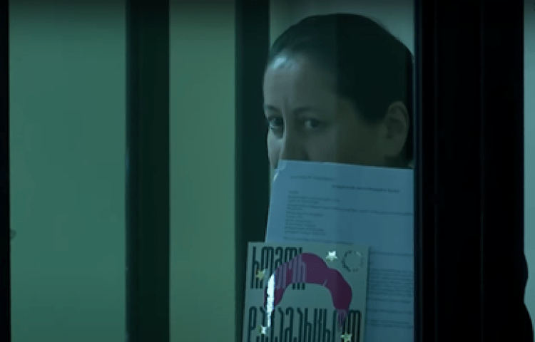 Mzia Amaghlobeli, director of two news outlets that regularly report on corruption and abuse of power, is seen in Georgia’s Batumi City Court, holding up journalist Maria Ressa's memoir “How to Stand Up to a Dictator," on January 14, 2025.